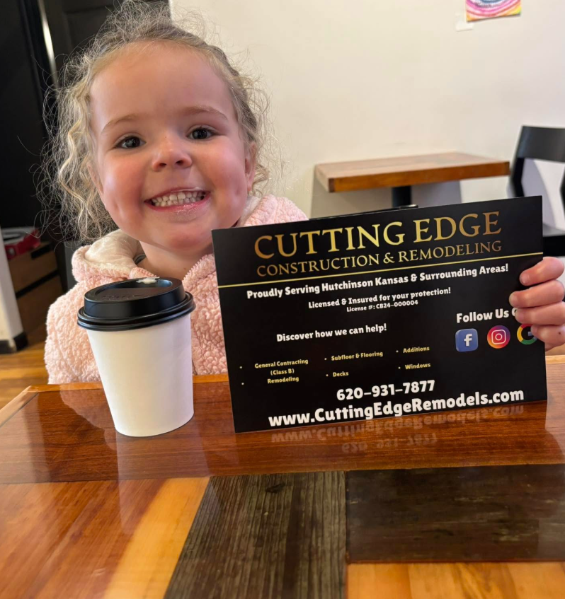 A little Scott baby holding the sacred Cutting Edge postcard